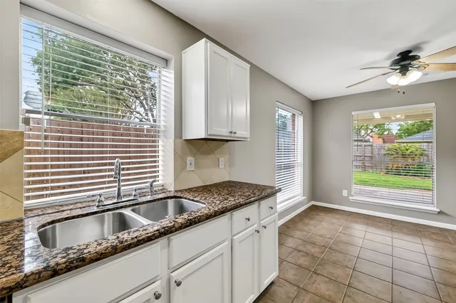 a kitchen with granite countertop a sink and a window
