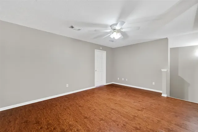 a view of an empty room with a fan
