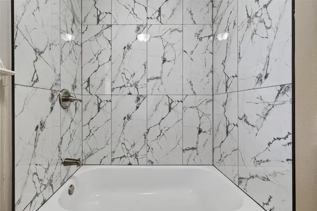 a bathroom with a bathtub and shower