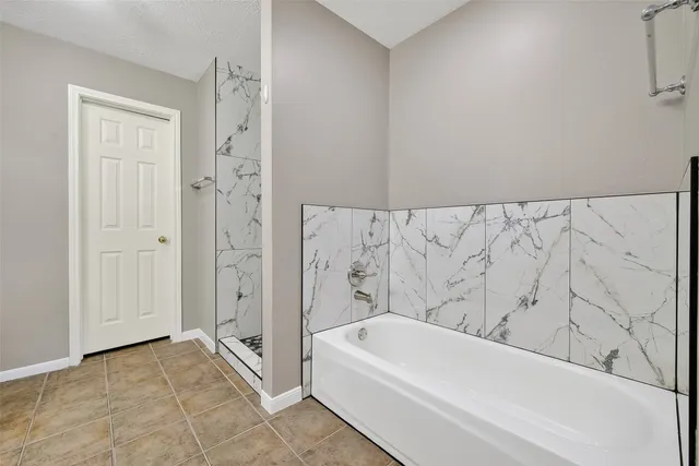 a bathroom with a bathtub and a shower