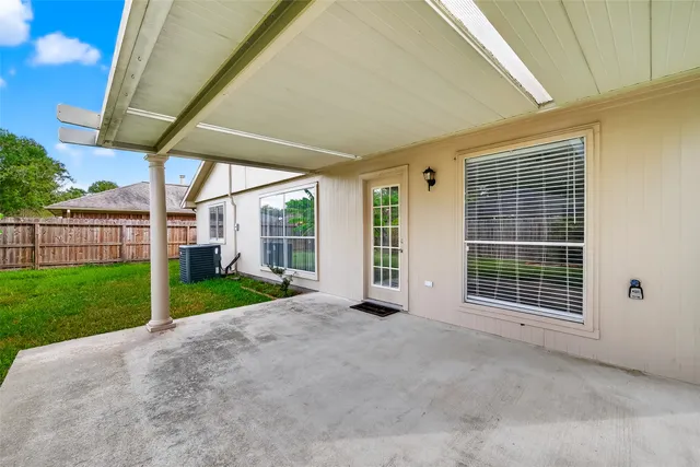 a view of a house with backyard and porch