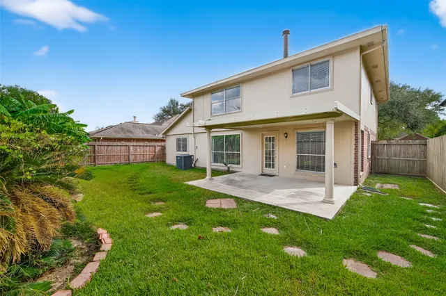 a view of a house with a yard and porch