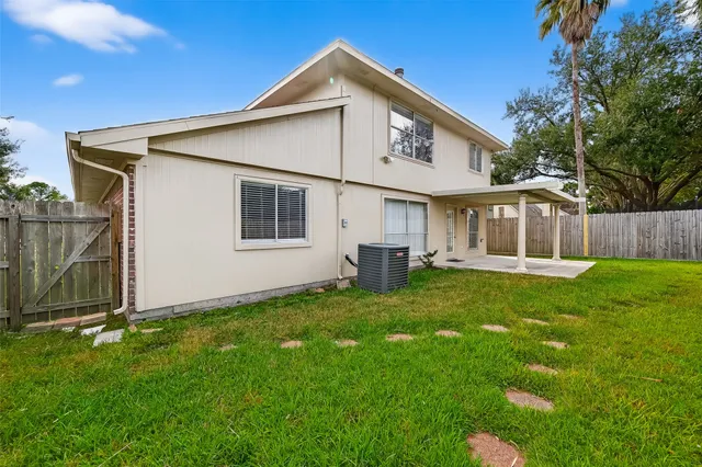 a view of an house with backyard space and garden