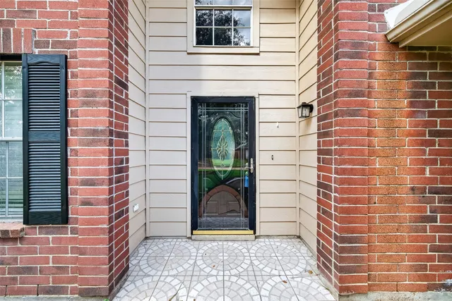 a view of a door and brick walls