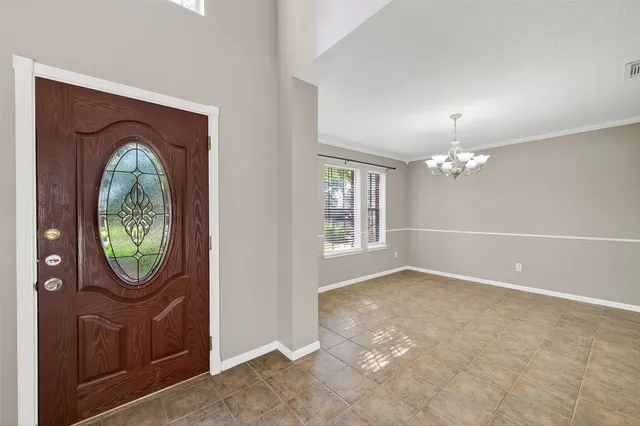 an empty room with windows cabinet and mirror