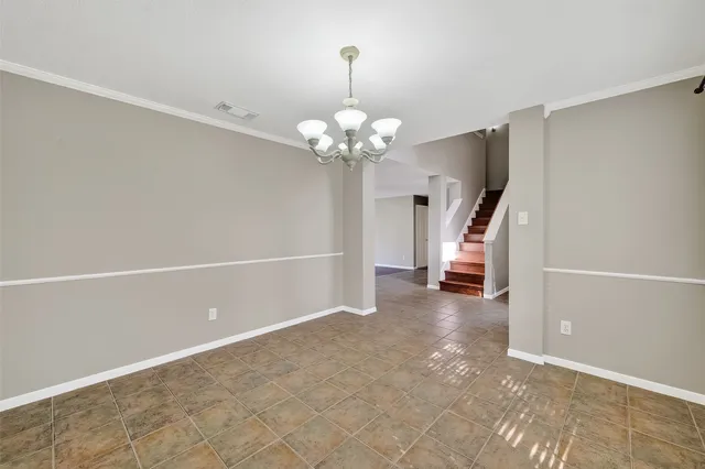 a view of a chandelier in big room and a chandelier fan