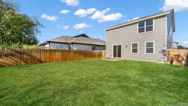a view of a house with a backyard