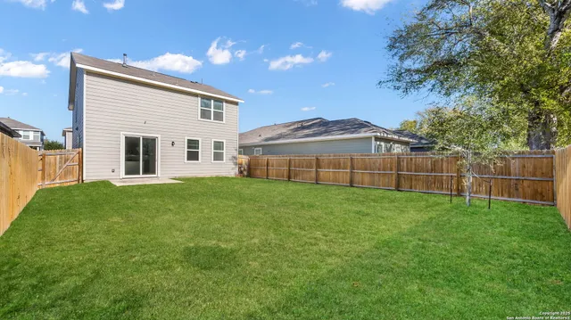 a view of a backyard with a garden and deck
