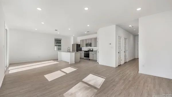 a view of kitchen with cabinets and wooden floor