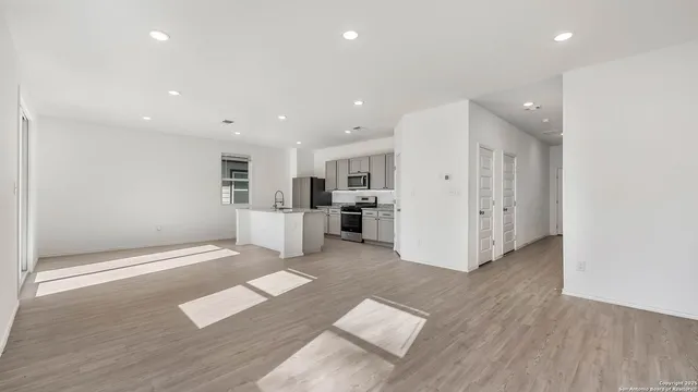 a view of kitchen with cabinets and wooden floor