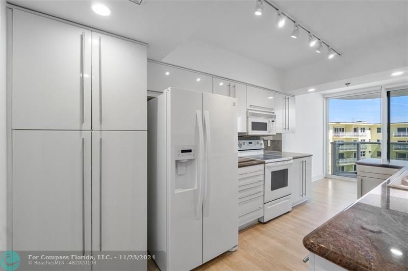 350 South Ocean Boulevard, Unit 5D Boca Raton, FL 33432 - Photo 11 of 35 a kitchen with stainless steel appliances a refrigerator sink and stove
