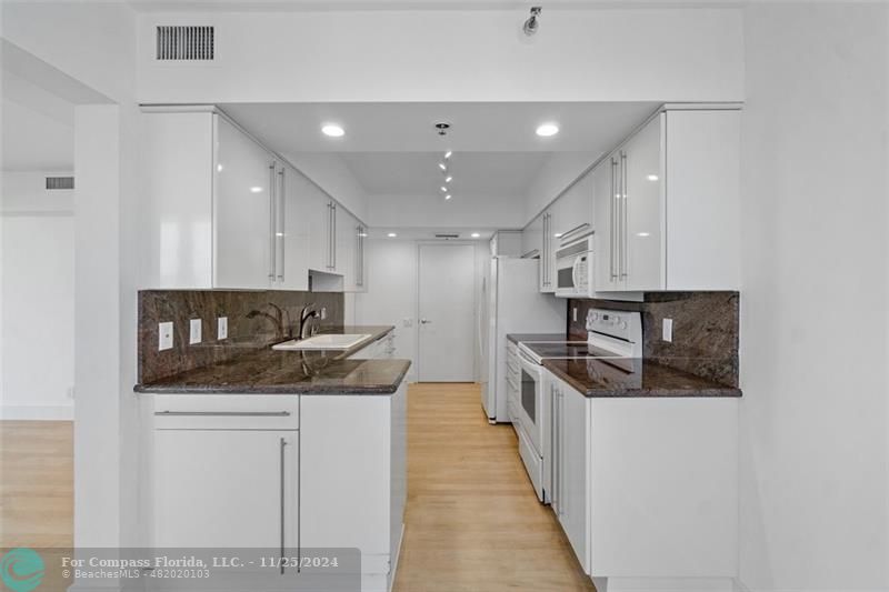 350 South Ocean Boulevard, Unit 5D Boca Raton, FL 33432 - Photo 12 of 35 a kitchen with stainless steel appliances granite countertop a sink and a stove