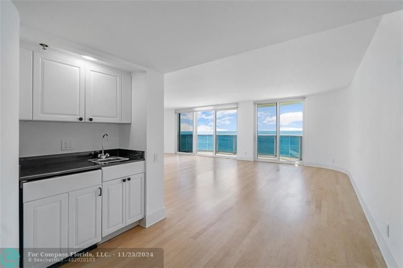 350 South Ocean Boulevard, Unit 5D Boca Raton, FL 33432 - Photo 8 of 35 a view of a kitchen with wooden floor and cabinets
