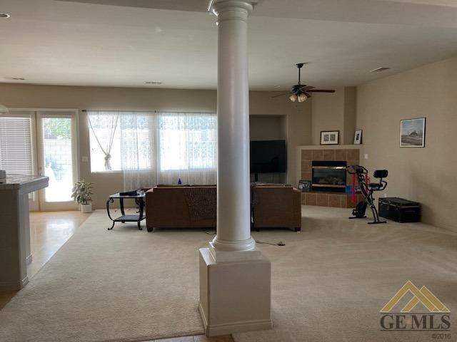Undisclosed Address Bakersfield, CA 93311 - Photo 16 of 23 a living room with furniture a flat screen tv and a fireplace
