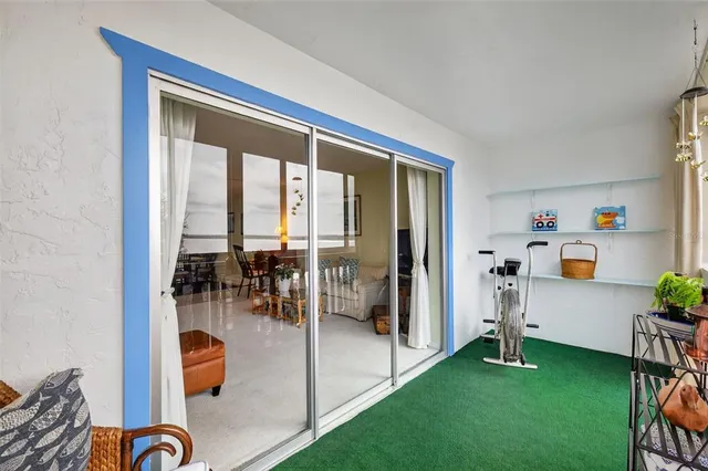 a living room with furniture a dining table and a chandelier