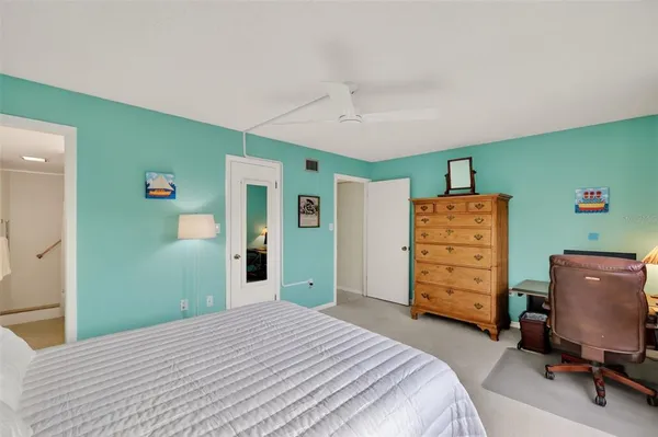 a bedroom with a bed and a dresser