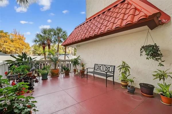 a view of outdoor space with seating area and potted plants