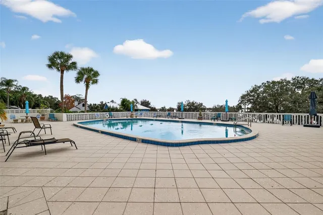 a view of a swimming pool with a patio