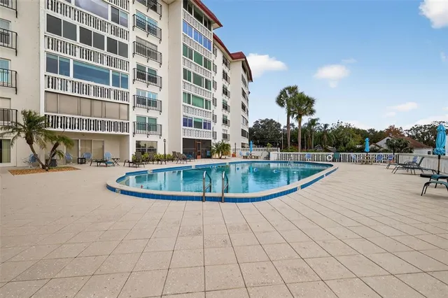 a view of a swimming pool with a lawn chairs