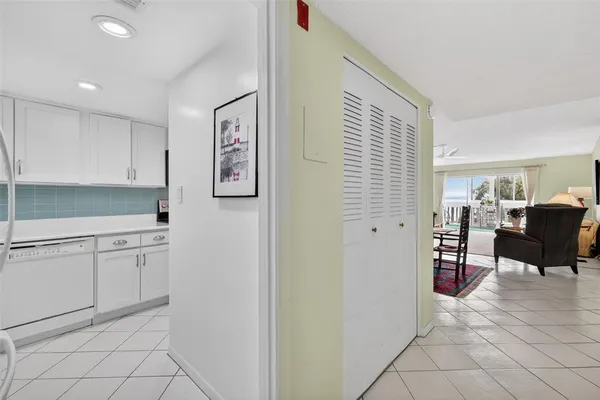 a hallway with cabinets and wooden floor