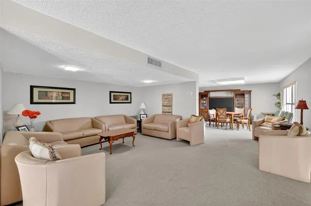 a living room with furniture and white walls