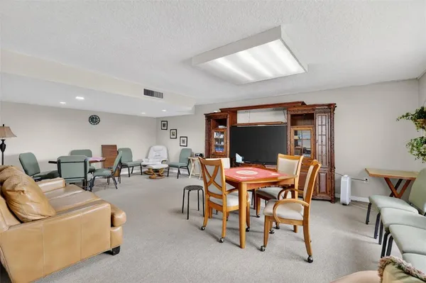 a dining room with furniture and a flat screen tv