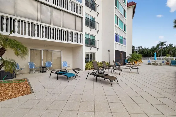 a view of a patio with dining table and chairs