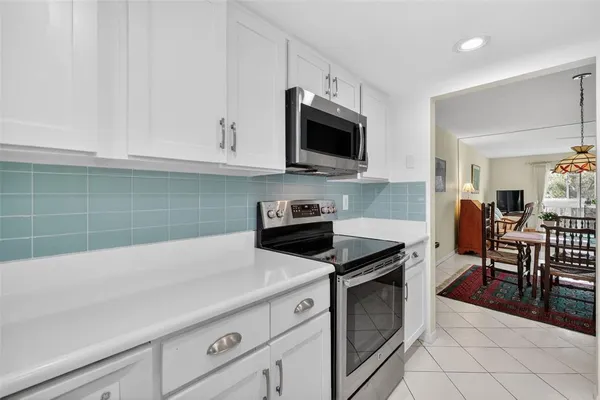 a kitchen with cabinets appliances and a sink