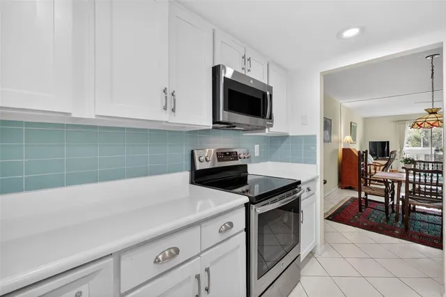 a kitchen with cabinets appliances and a sink