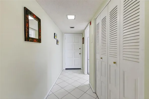 a view of a hallway with wooden shelves