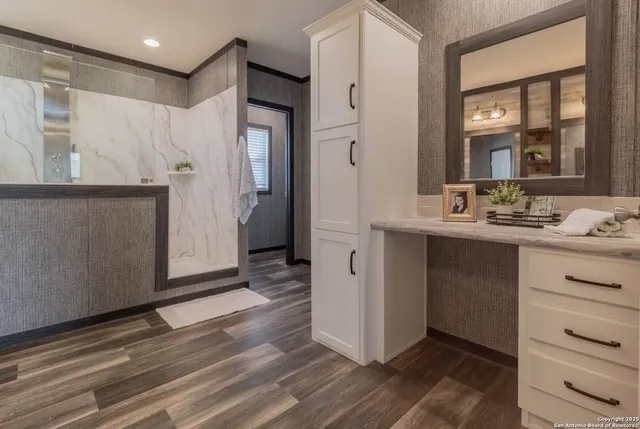 an empty room with a ceiling fan and window