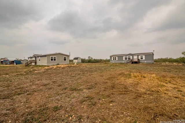 a view of a livingroom with furniture wooden floor and windows