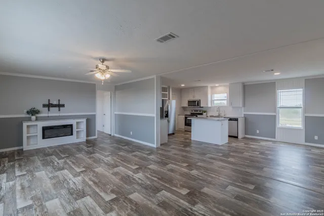 a bedroom with a bed window and wooden floor