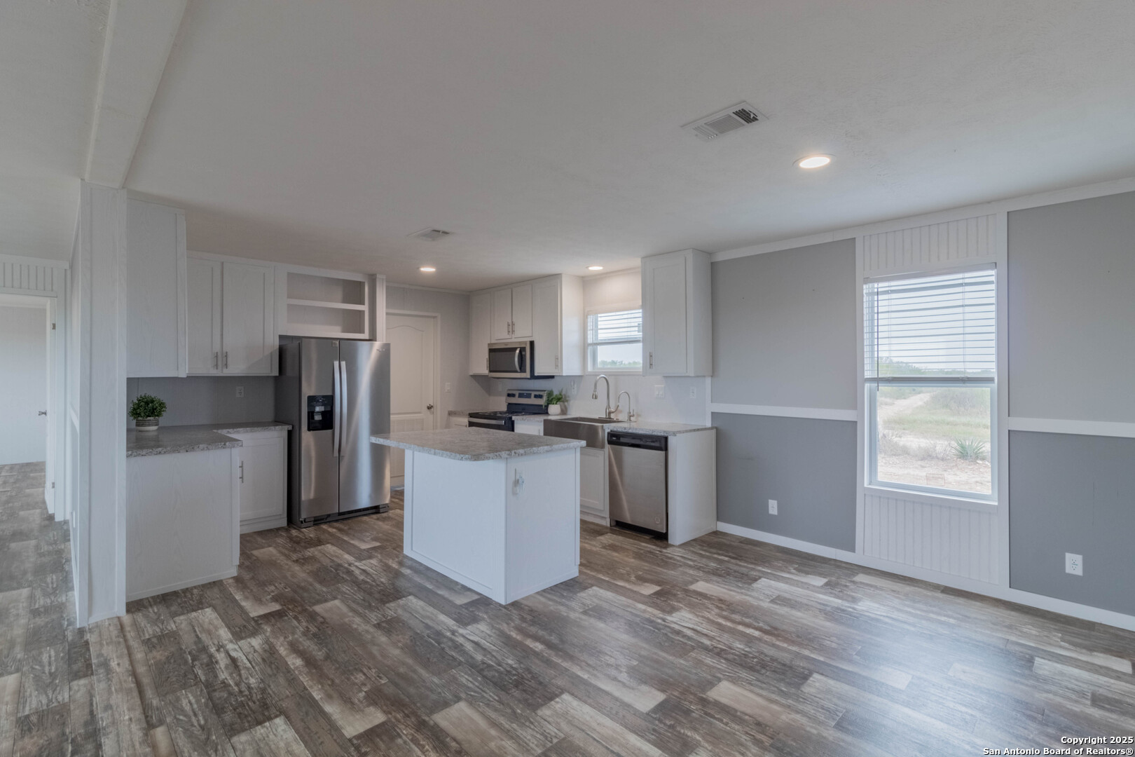 290 Lilly Bear Lane Moore, TX 78057 - Photo 44 of 62 a kitchen with refrigerator and windows
