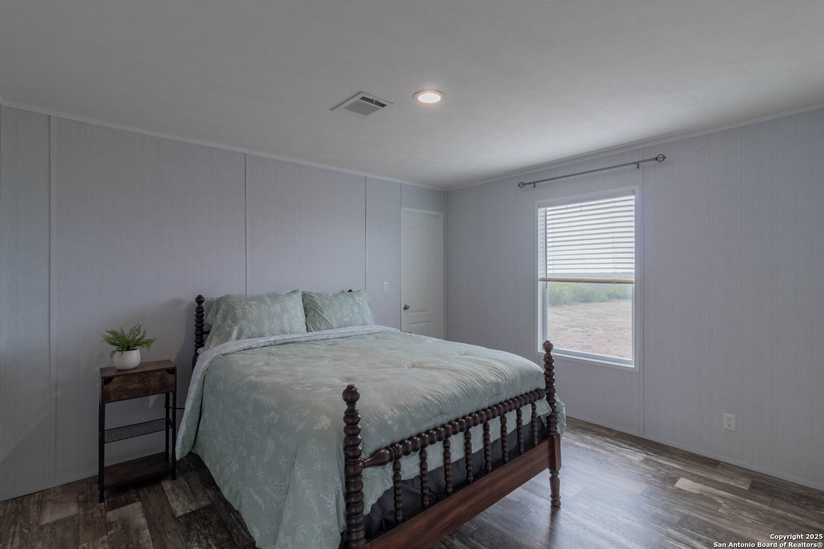 290 Lilly Bear Lane Moore, TX 78057 - Photo 53 of 62 a bedroom with a bed window and wooden floor