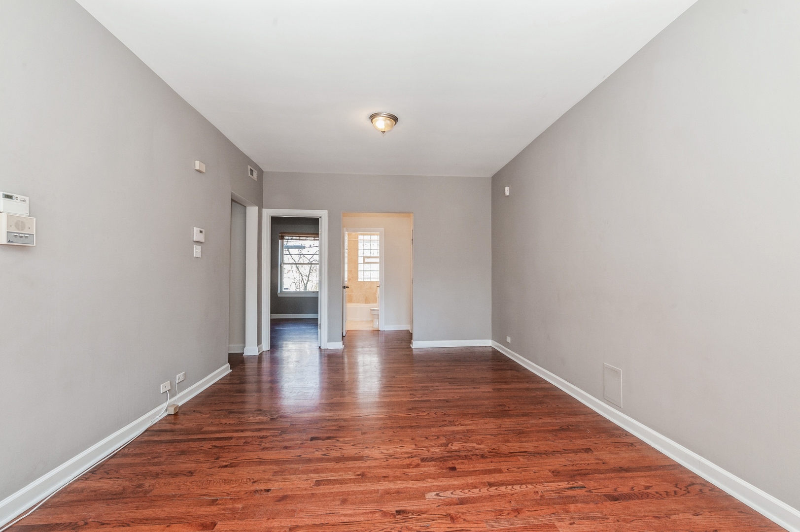 5743 North Ridge Avenue, Unit 1 Chicago, IL 60660 - Photo 3 of 12 a view of an empty room with wooden floor and closet