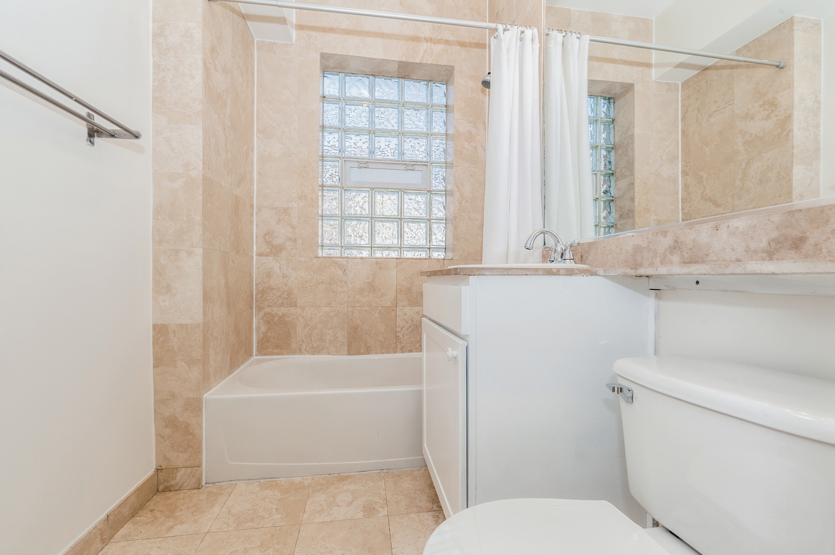 5743 North Ridge Avenue, Unit 1 Chicago, IL 60660 - Photo 10 of 12 a bathroom with a sink a toilet and a bathtub