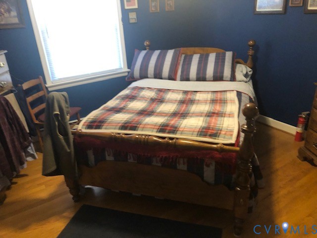 9401 Gum Fork Road Midlothian, VA 23112 - Photo 25 of 28 a bed sitting in a bedroom next to a window