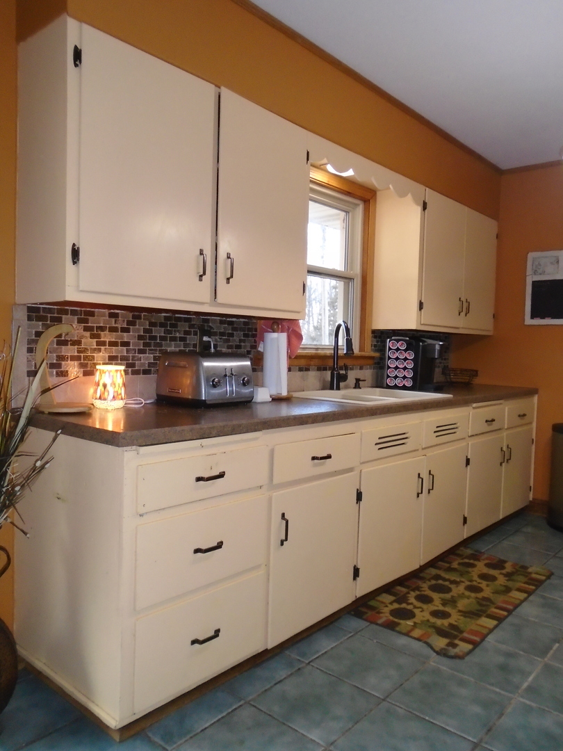 4121 East 2nd Road Mendota, IL 61342 - Photo 9 of 31 a kitchen with appliances a sink and cabinets