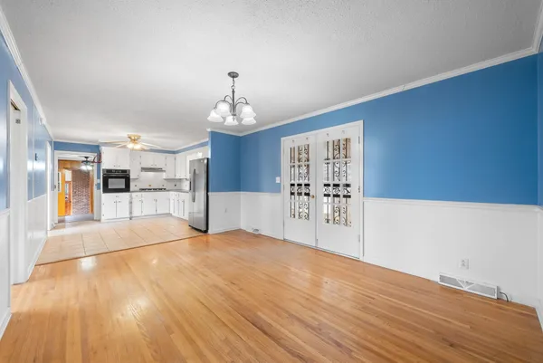 a view of a kitchen with wooden floor and kitchen space