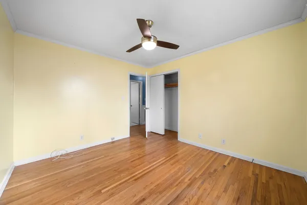 a view of an empty room with wooden floor
