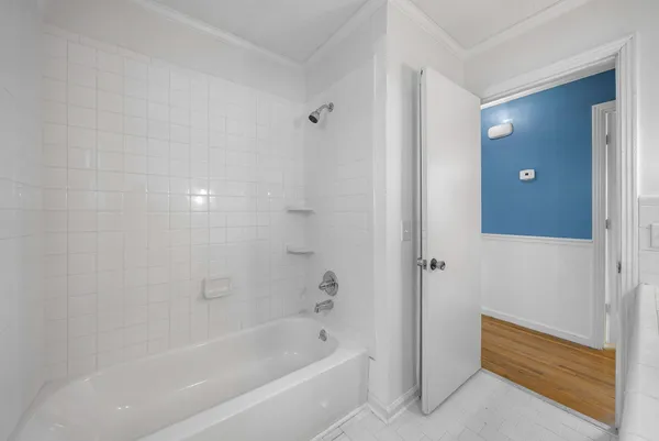 a bathroom with a bathtub and shower