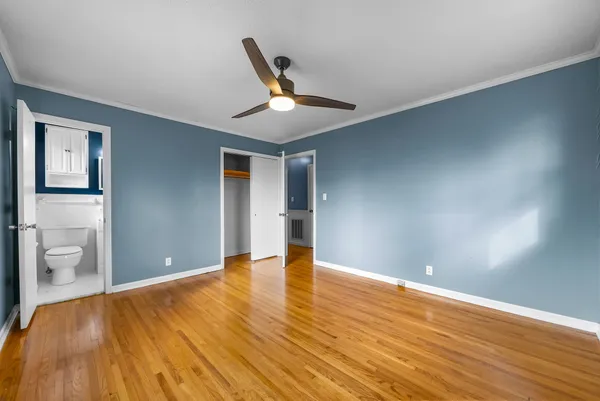 a view of an empty room and wooden floor