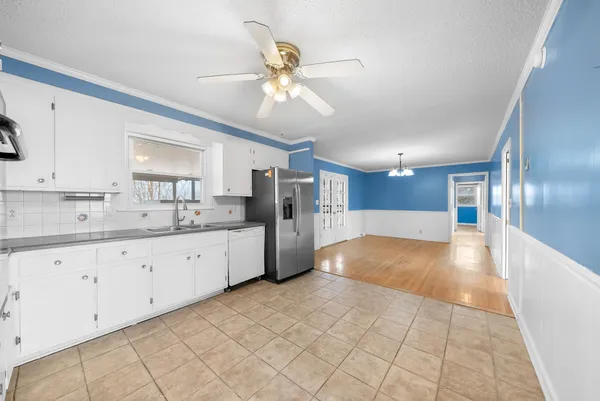 a view of a kitchen with a sink and cabinets