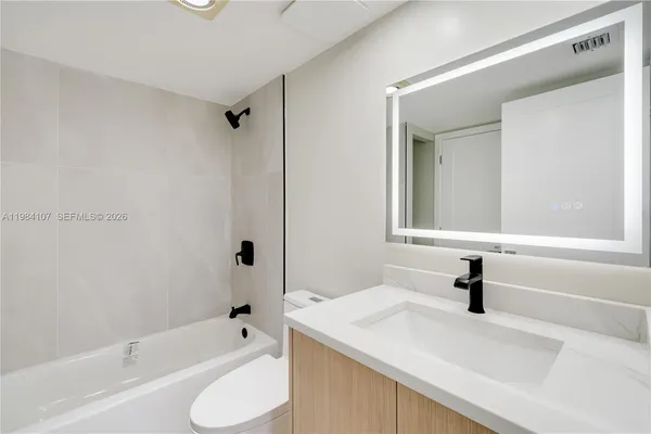 a bathroom with a sink a toilet and a bathtub