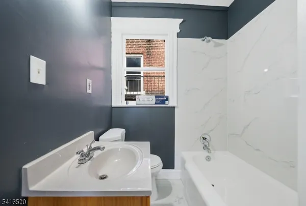 a bathroom with a sink mirror and a bathtub
