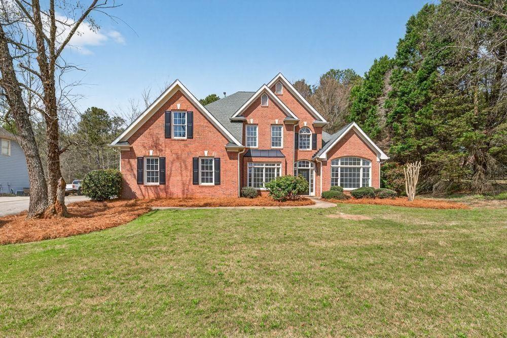 a front view of a house with a yard