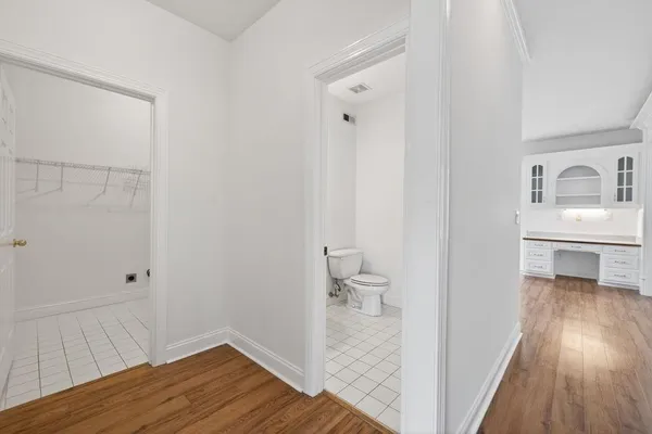a view of an empty room with a fireplace and a window
