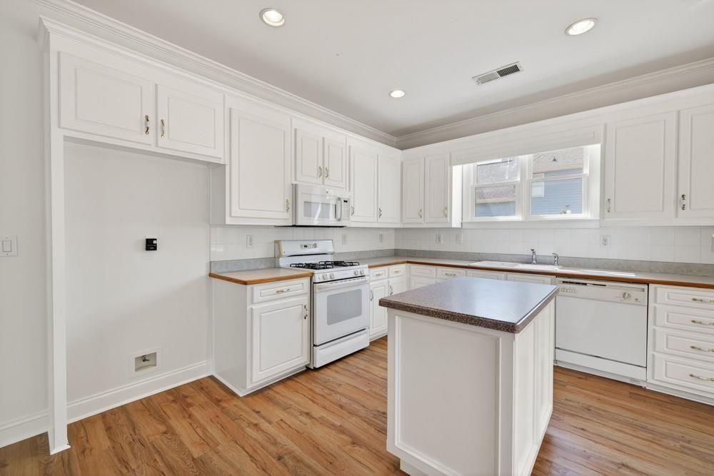 7512 Fieldstone Way Monroe, GA 30656 - Photo 19 of 49 a kitchen with granite countertop white cabinets and white appliances