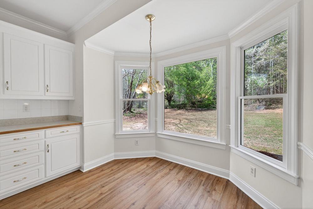 7512 Fieldstone Way Monroe, GA 30656 - Photo 20 of 49 a view of an empty room with wooden floor and a window